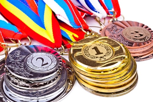 Gold, silver and bronze medal props will make fun gifts for your guests.